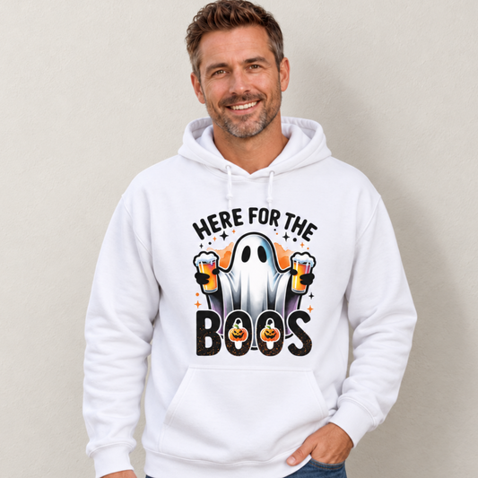 Man wearing a white hoodie with a Halloween ghost holding two beer mugs and the words Here For The Boos.