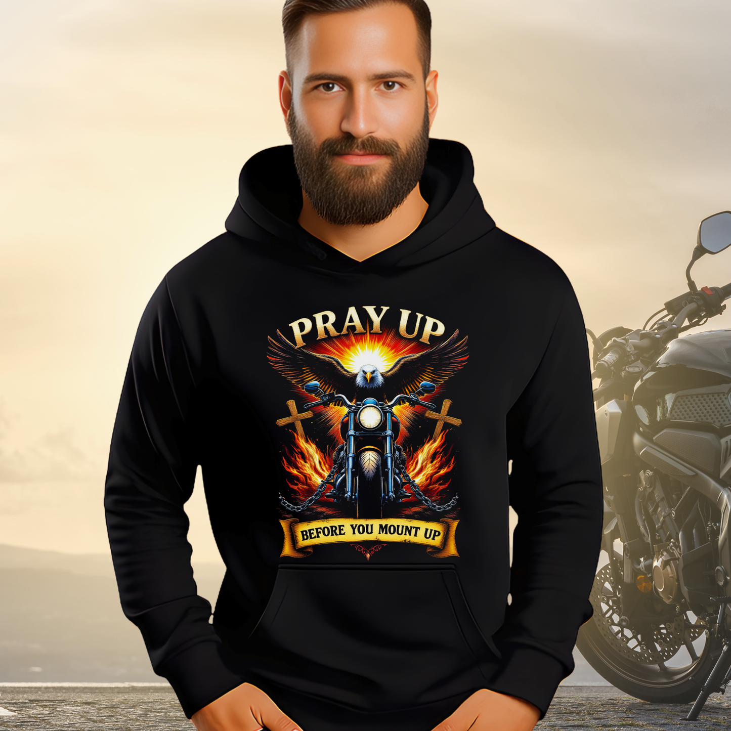 Outdoor photo of man in black hoodie with eagle and motorcycle faith design.