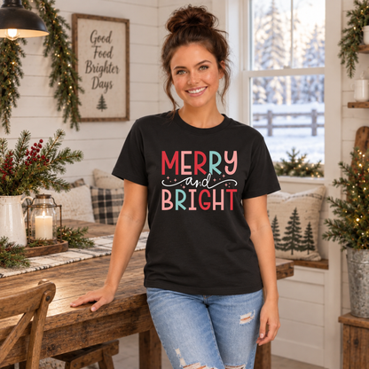 Woman wearing a black T-shirt with colorful Merry and Bright Christmas design in a cozy holiday dining room