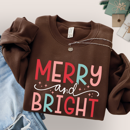 brown sweatshirt flat lay with merry and bright pastel holiday print, unisex christmas crewneck, black friday sale gift idea