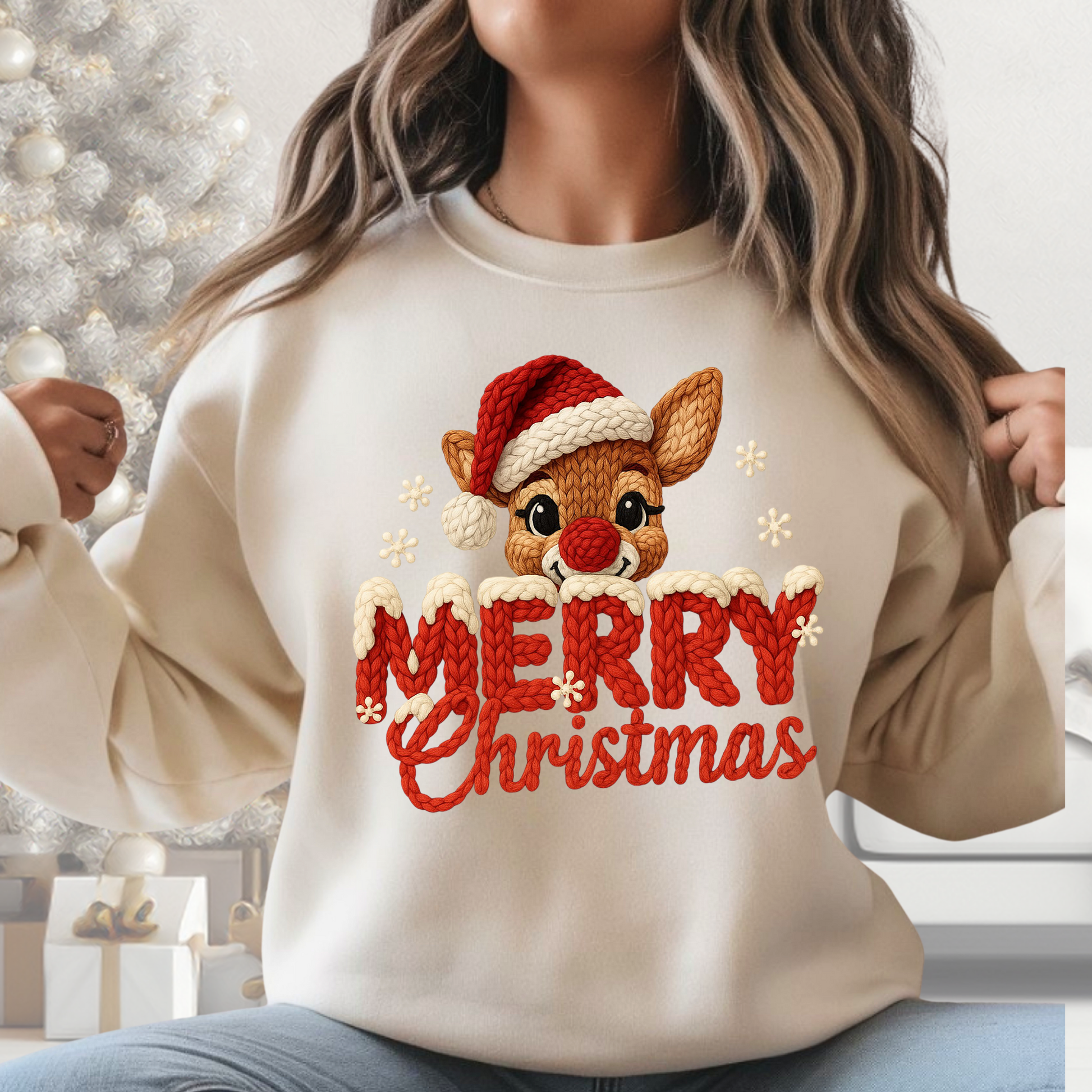 Woman wearing cream Merry Christmas reindeer chunky knit look sweatshirt in neutral holiday room