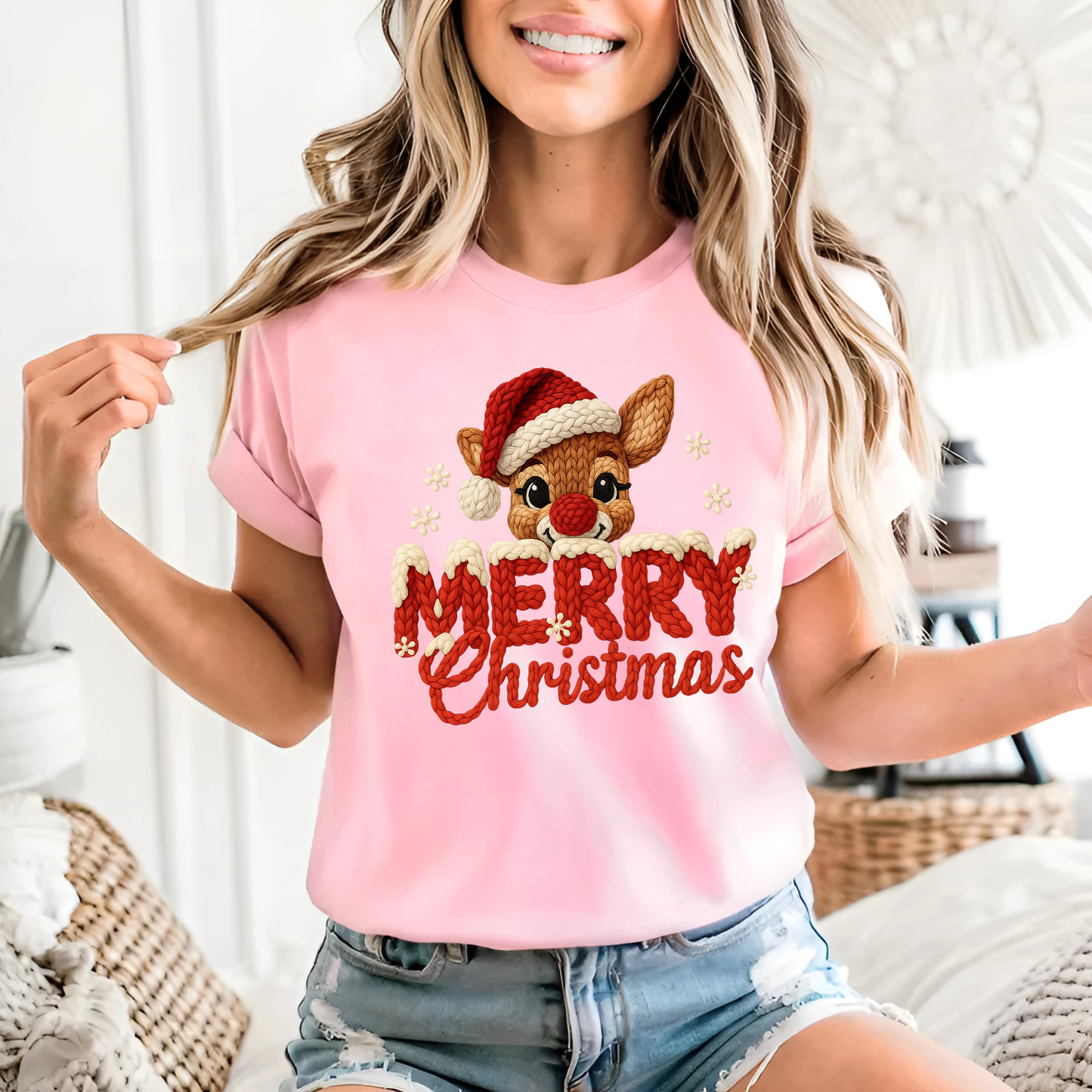 Person wearing a pink 'Merry Christmas' t-shirt with a reindeer design.