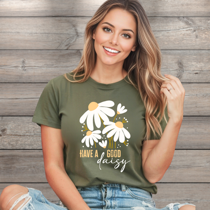Woman wearing a green t-shirt with floral design and text against a wooden background