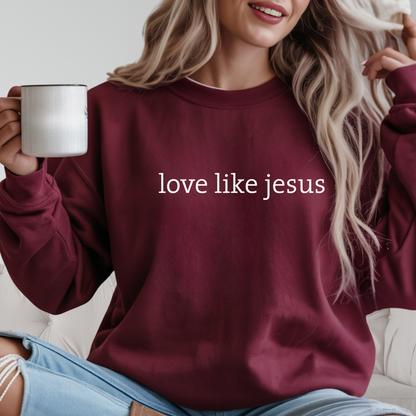 Woman wearing maroon “Love Like Jesus” crewneck holding coffee mug