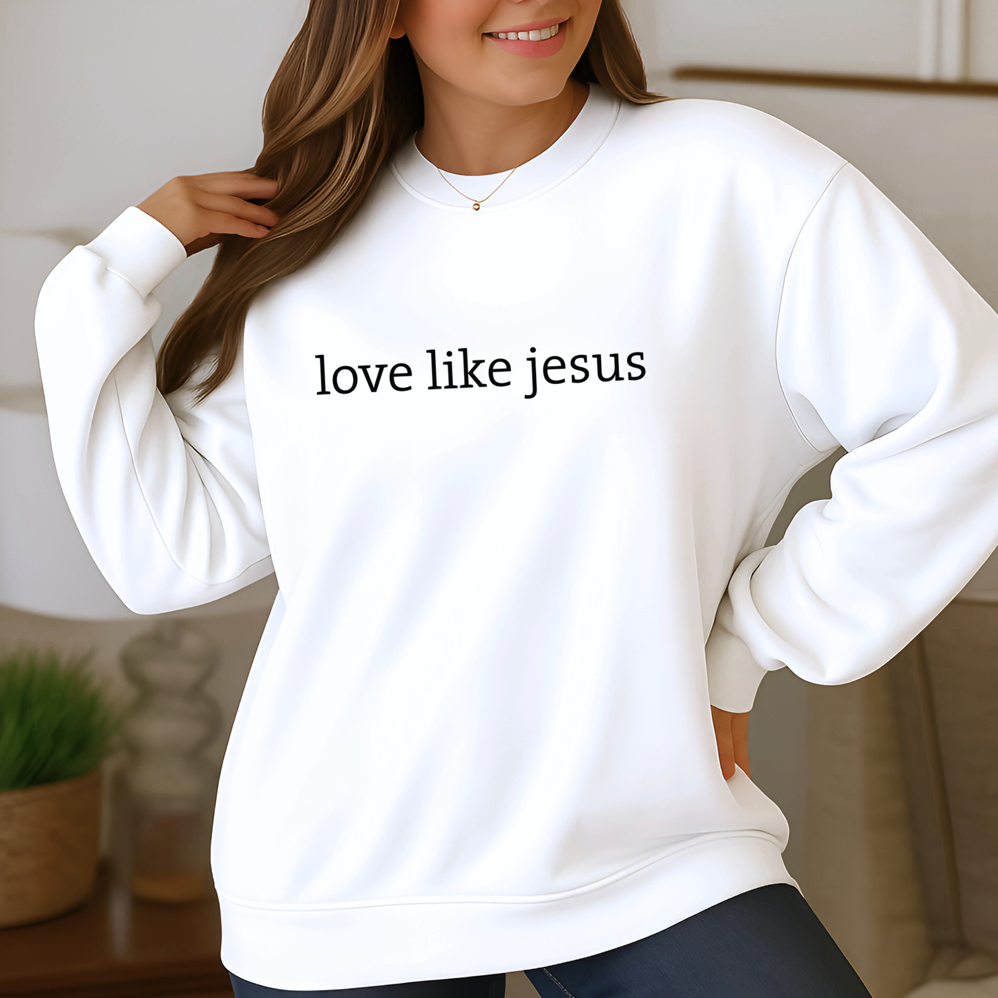Woman wearing white “Love Like Jesus” crewneck, soft natural lighting