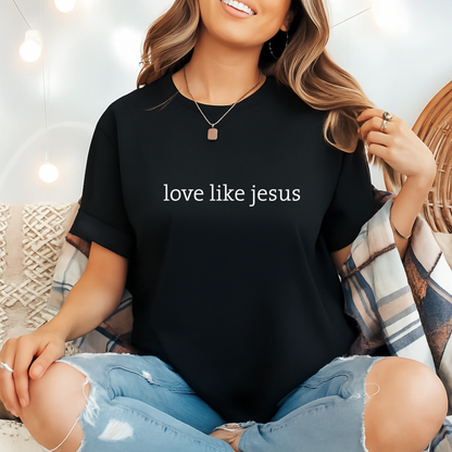 Woman in black “Love Like Jesus” shirt with plaid flannel, cozy indoor style