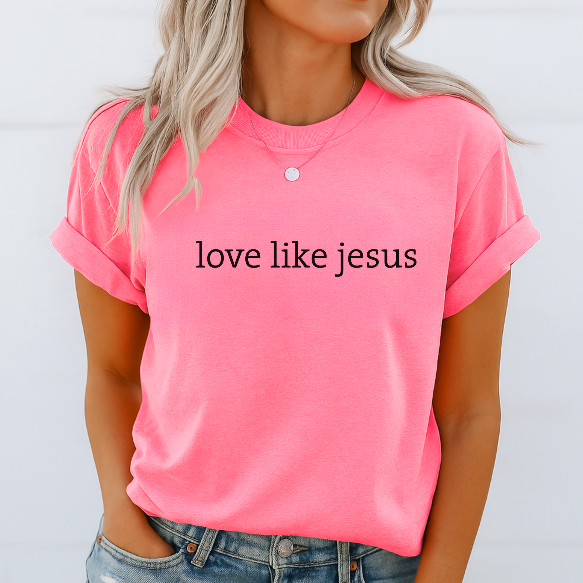 Woman in bright pink “Love Like Jesus” tee, rolled sleeves, summer look