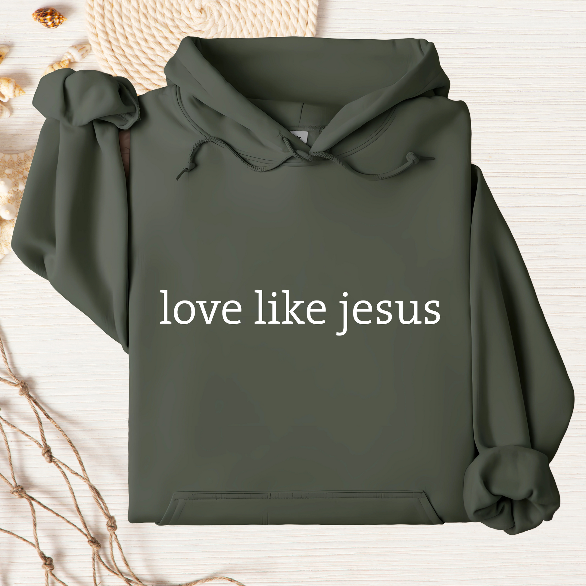 Flat lay olive green hoodie with “love like jesus” white text on light background