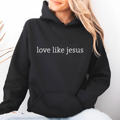 Lifestyle image of woman wearing black hoodie with “love like jesus” white text