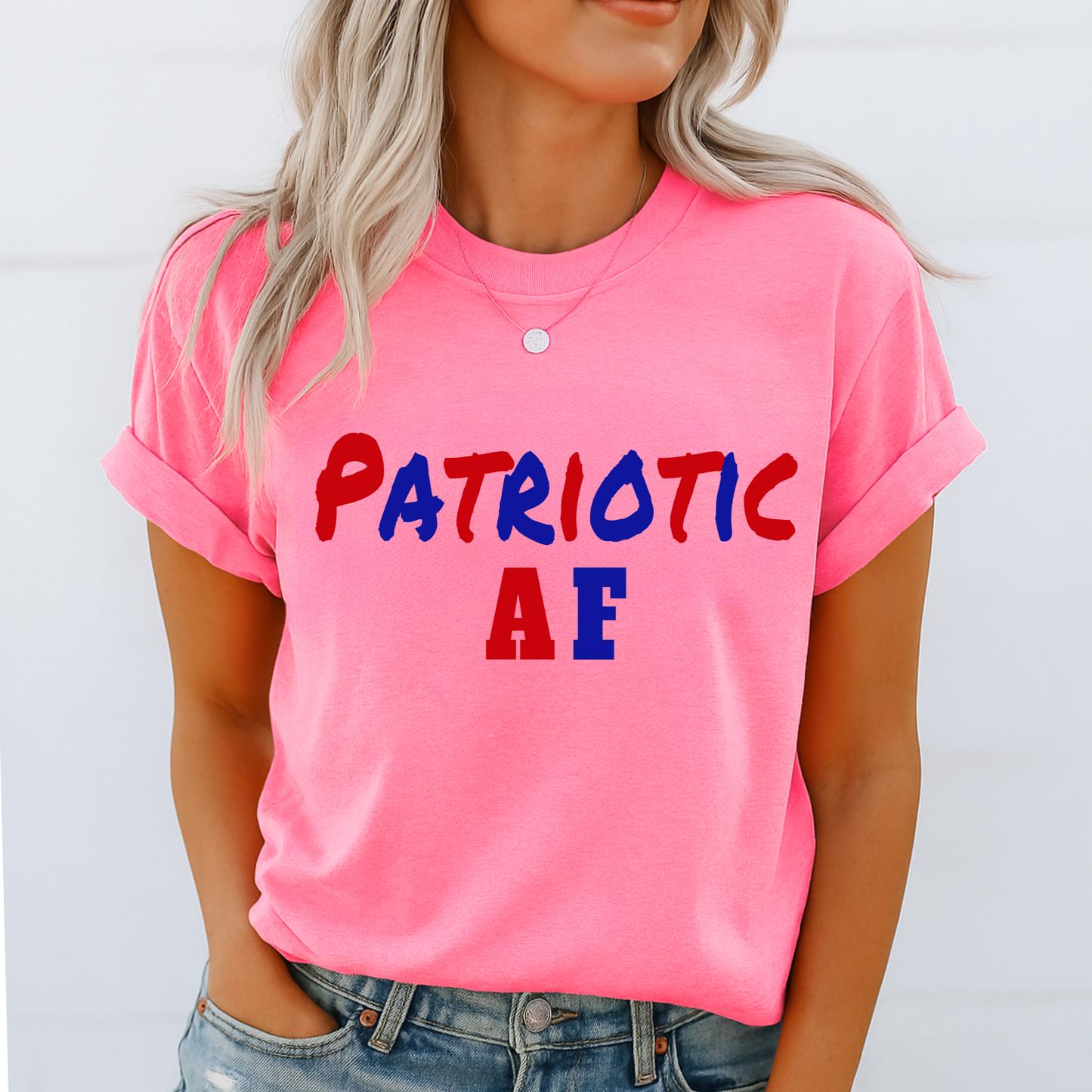 Model in bright safety pink “Patriotic AF” tee, styled casually with denim