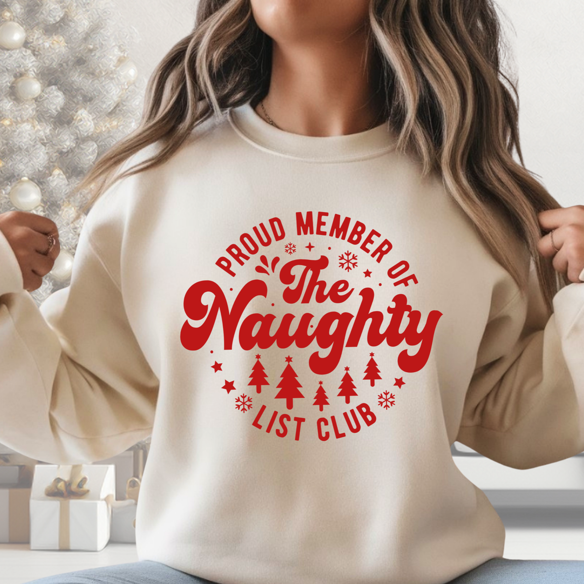 Sand-colored sweatshirt with red “Proud Member of the Naughty List Club” design – unisex Christmas pullover.