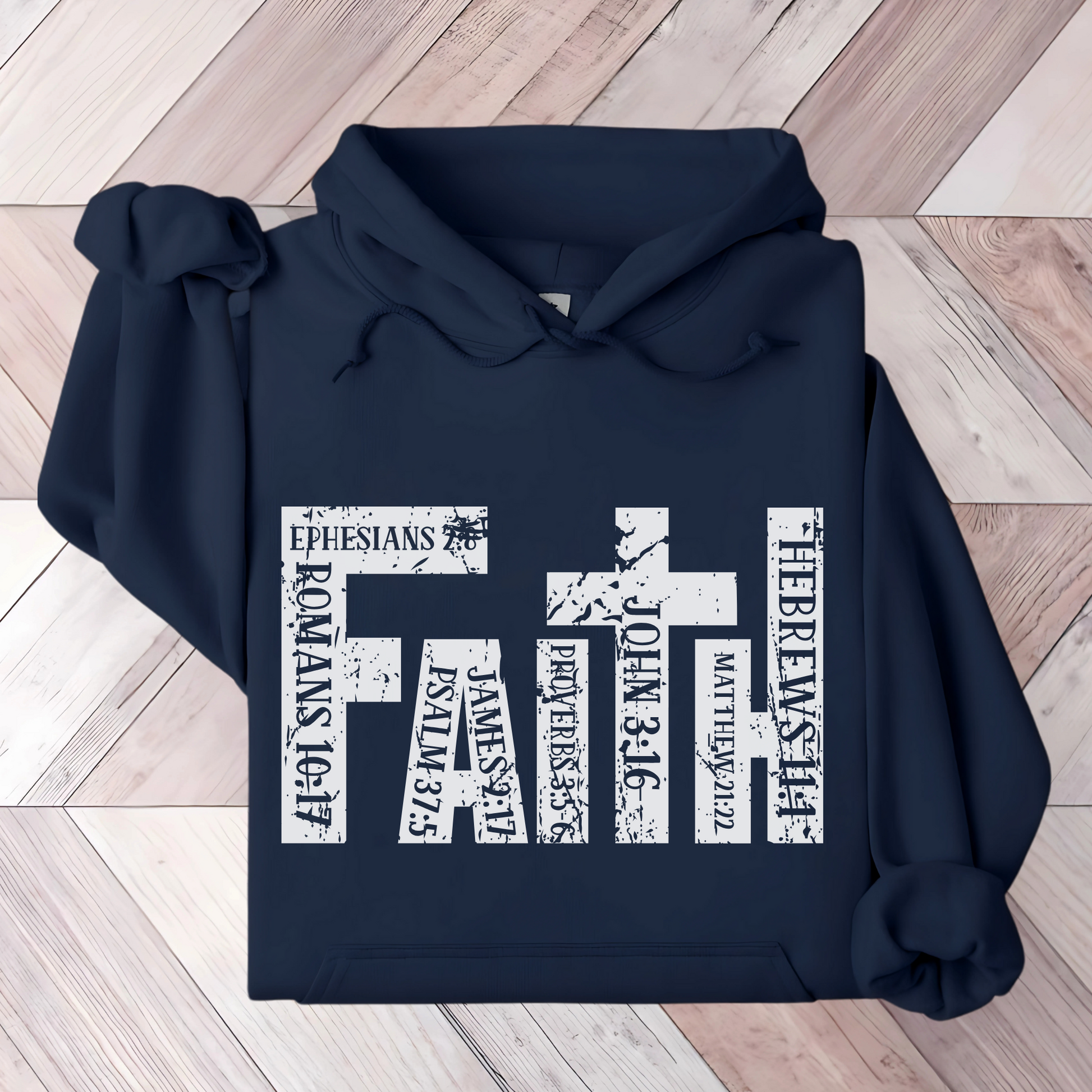 "Navy blue Christian hoodie featuring 'FAITH' in bold distressed white letters, designed with Bible verse references including John 3:16, Romans 10:17, Hebrews 11:1, and more. Inspirational religious sweatshirt for faith-based fashion.