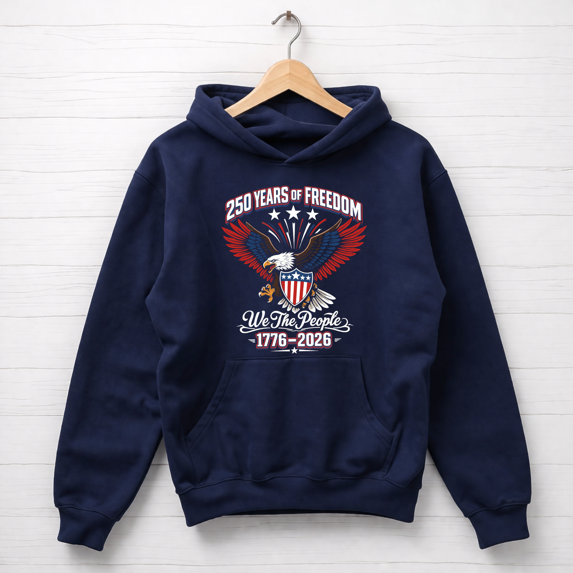 Navy blue America 250 hoodie with an eagle and American flag design on a white wooden background