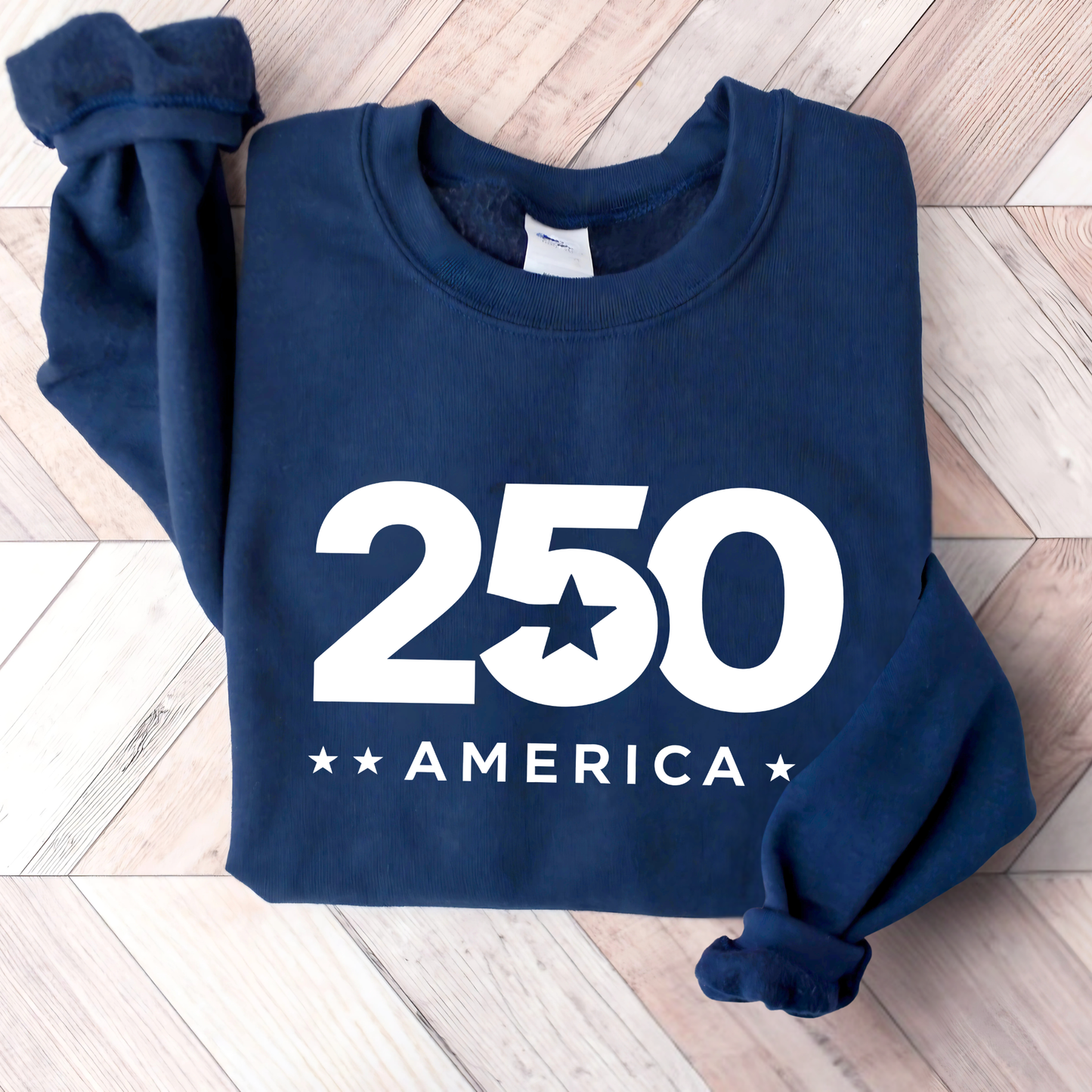 Navy blue sweatshirt with '250 America' print on a wooden floor