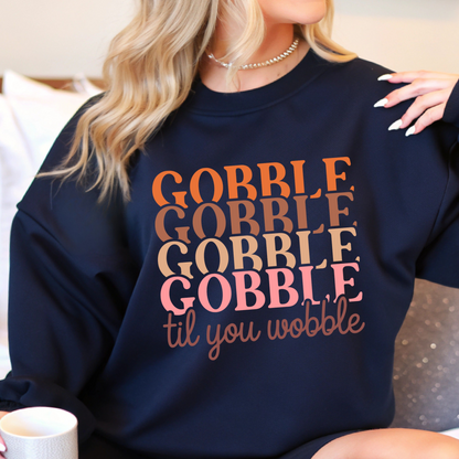 Navy blue sweatshirt with multicolor “Gobble Til You Wobble” design – perfect for fall family gatherings and seasonal style.