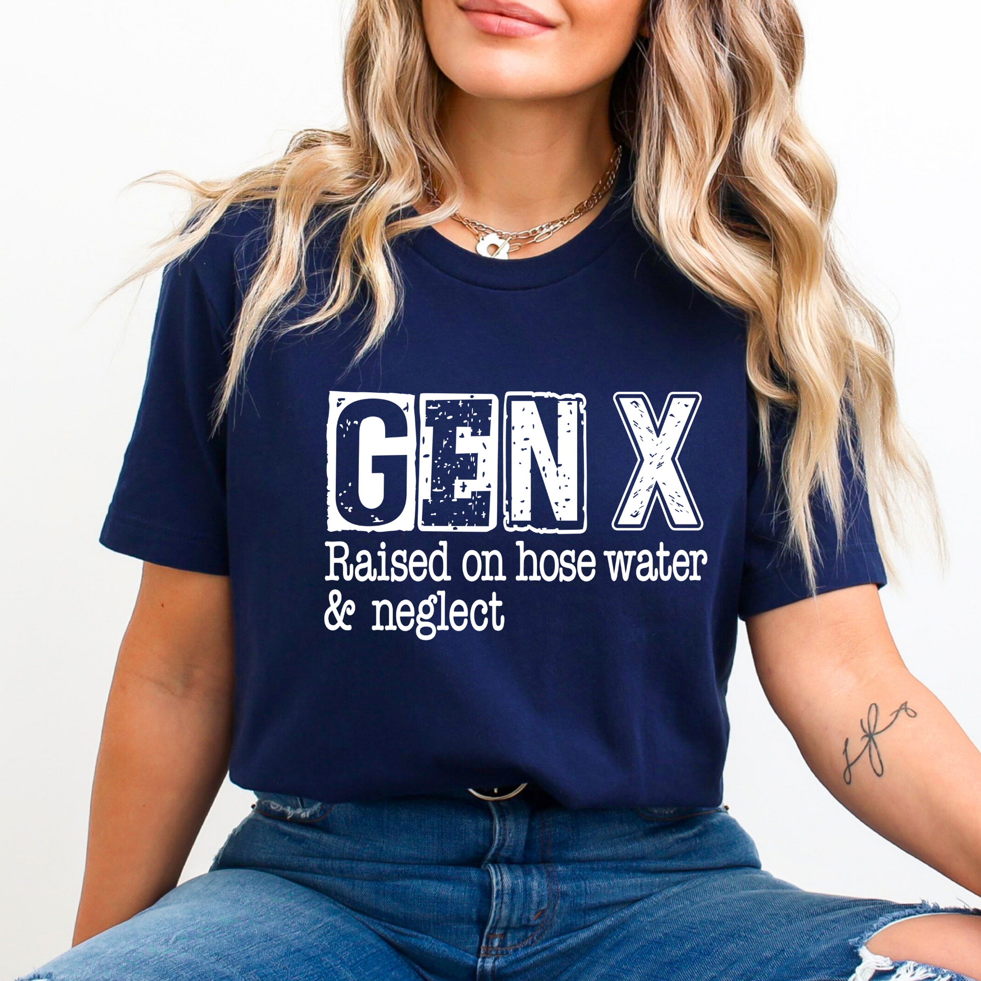Navy blue tee with white “GEN X Raised on hose water & neglect” text worn by woman sitting