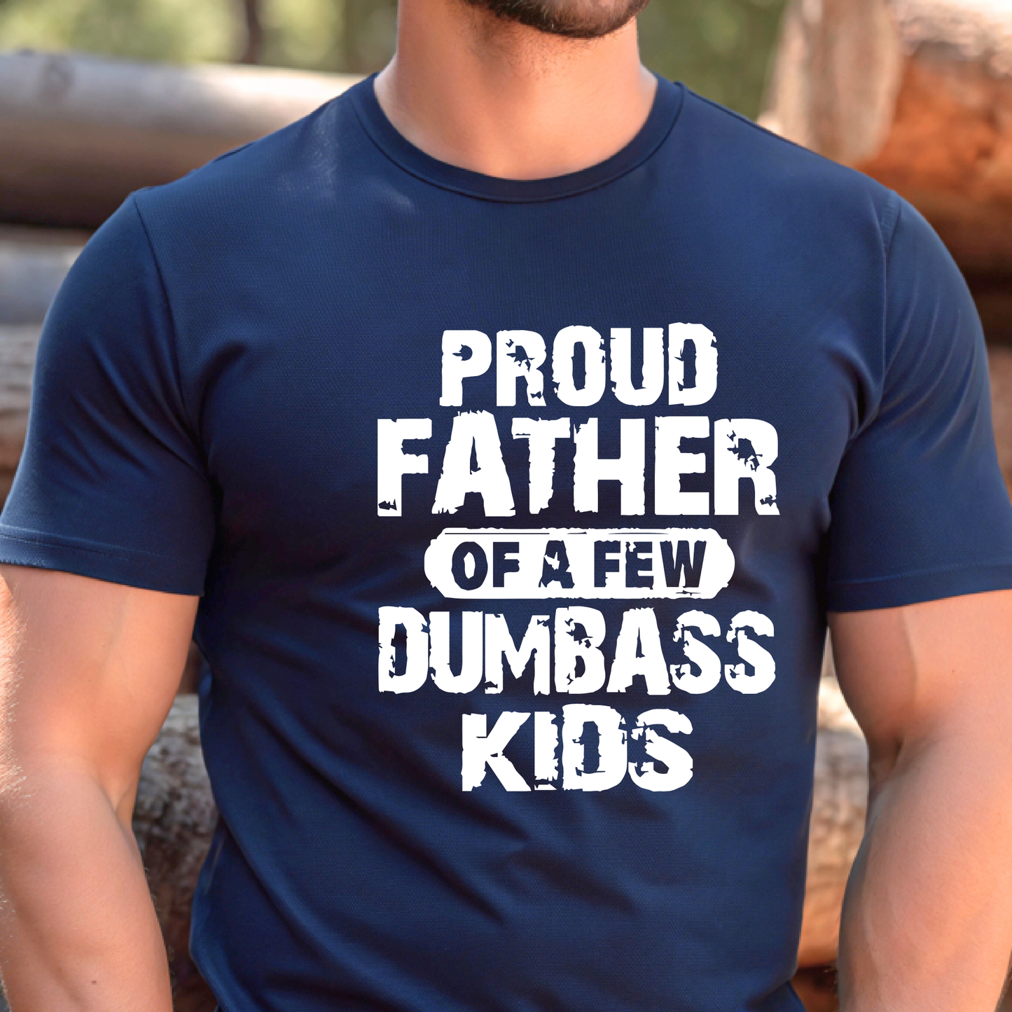 Navy blue t-shirt with white text 'Proud Father of a Few Dumbass Kids' worn by a person.