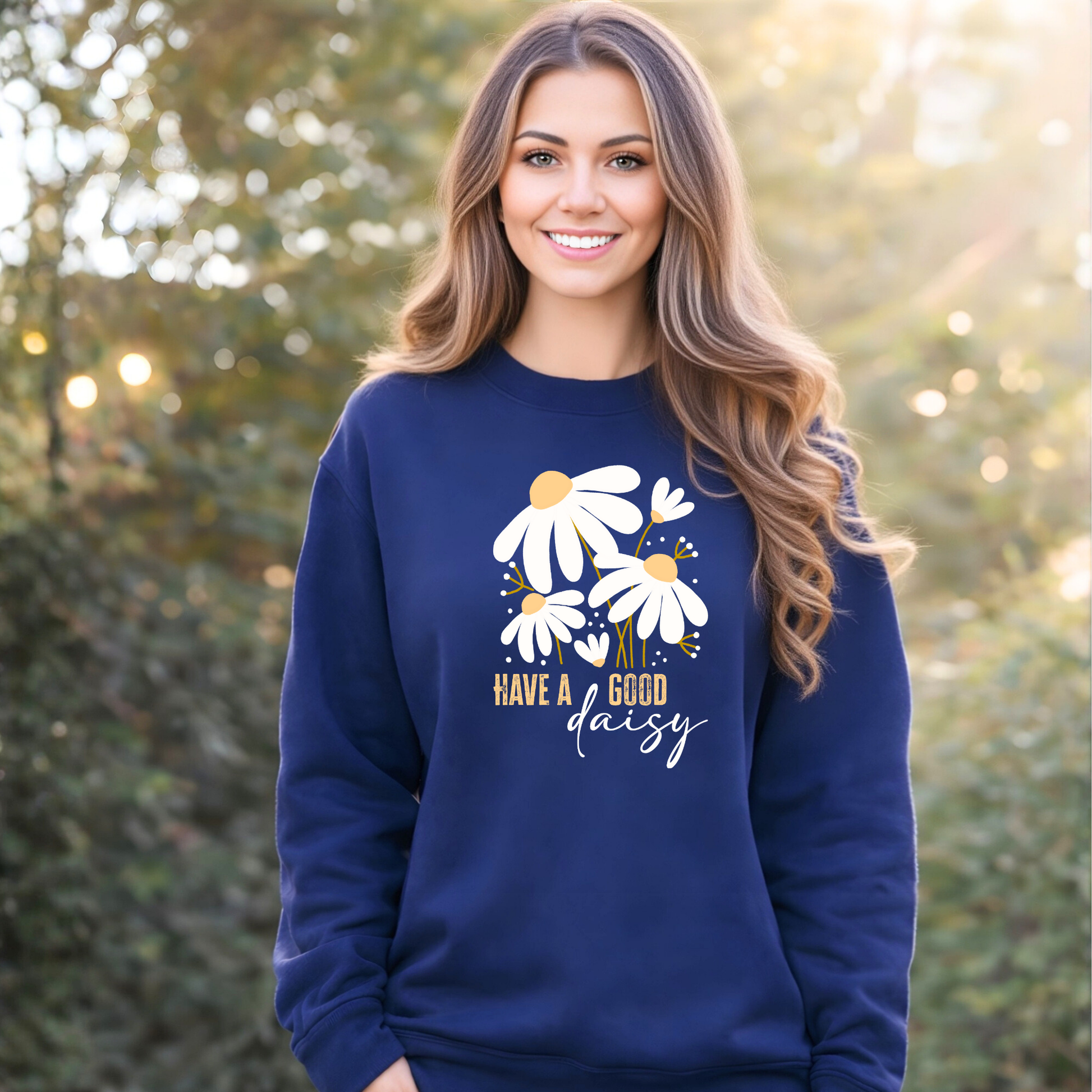 Woman wearing a blue sweatshirt with floral design and text outdoors