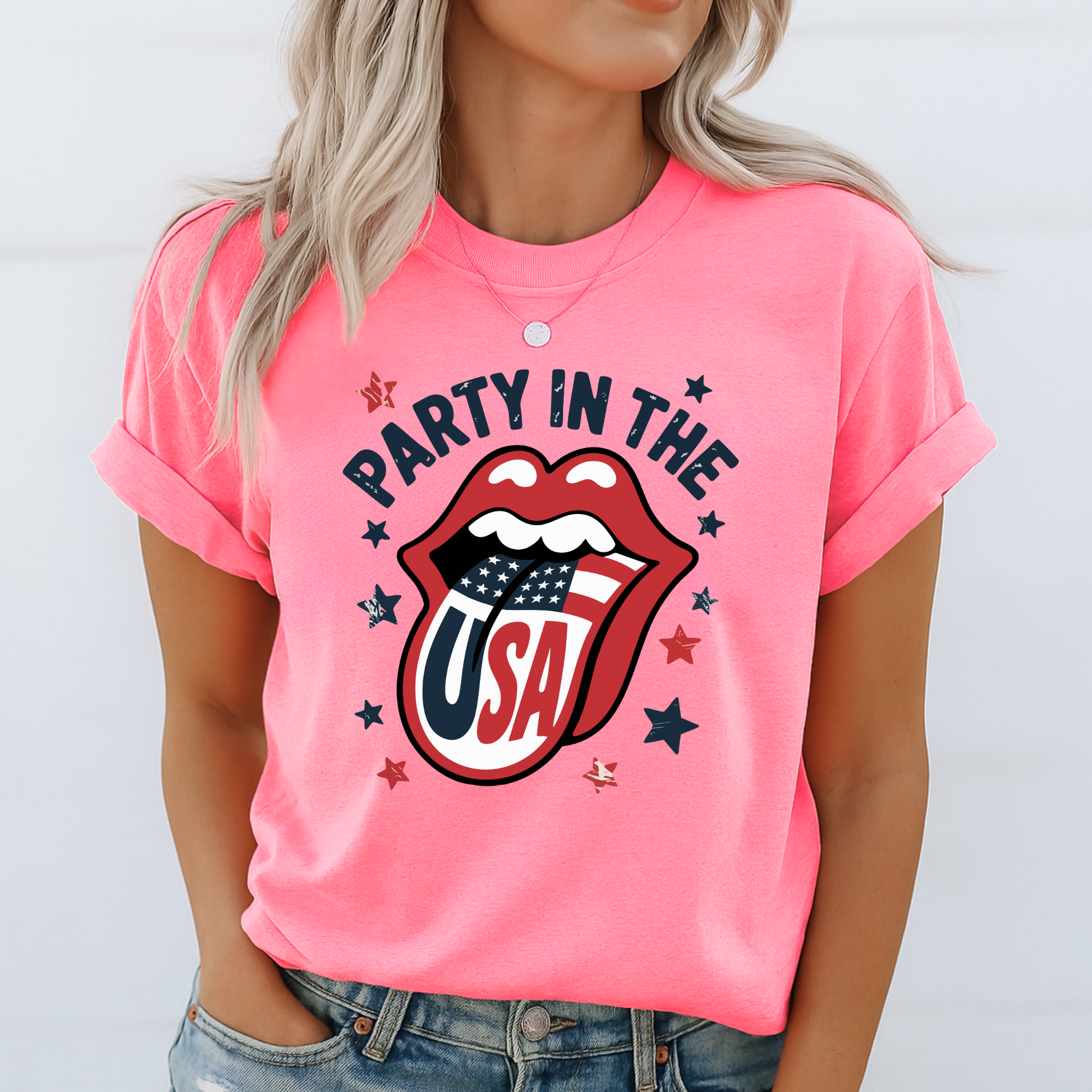 Woman in a bright neon pink “Party in the USA” shirt with flag tongue graphic, stars, and bold retro style. Fun and festive option for July 4th, pool parties, or matching family photos.

