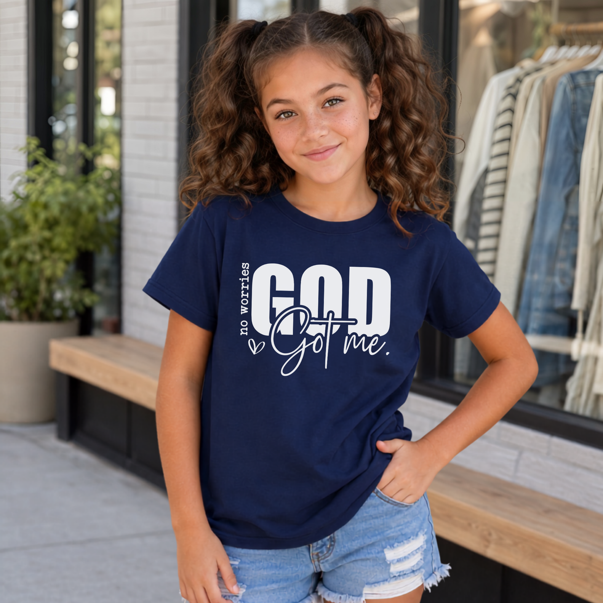 Navy No Worries God Got Me youth T-shirt with bold white Christian faith graphic.