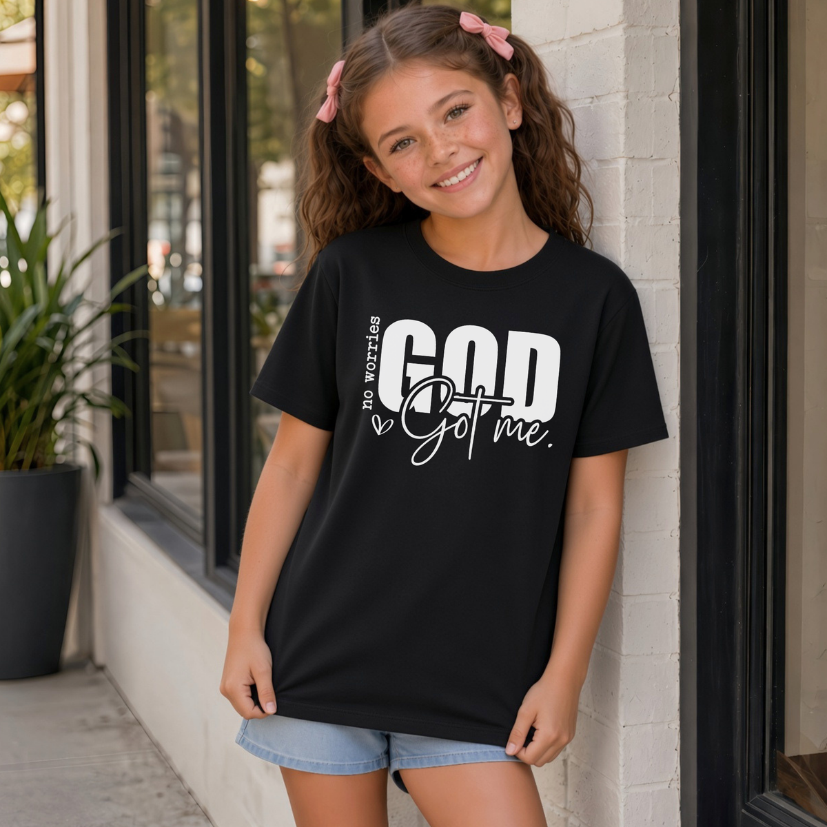 Black No Worries God Got Me youth T-shirt with bold white Christian faith graphic.