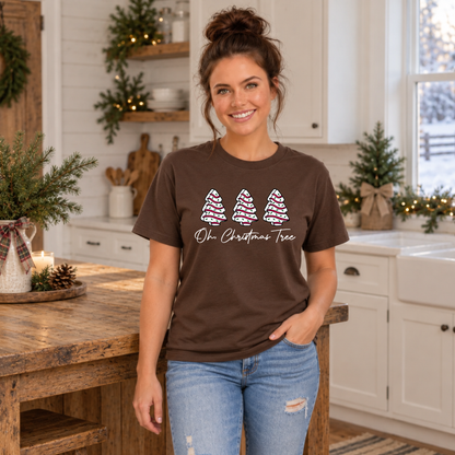 Woman wearing a brown Oh Christmas Tree T-shirt in a bright Christmas kitchen.