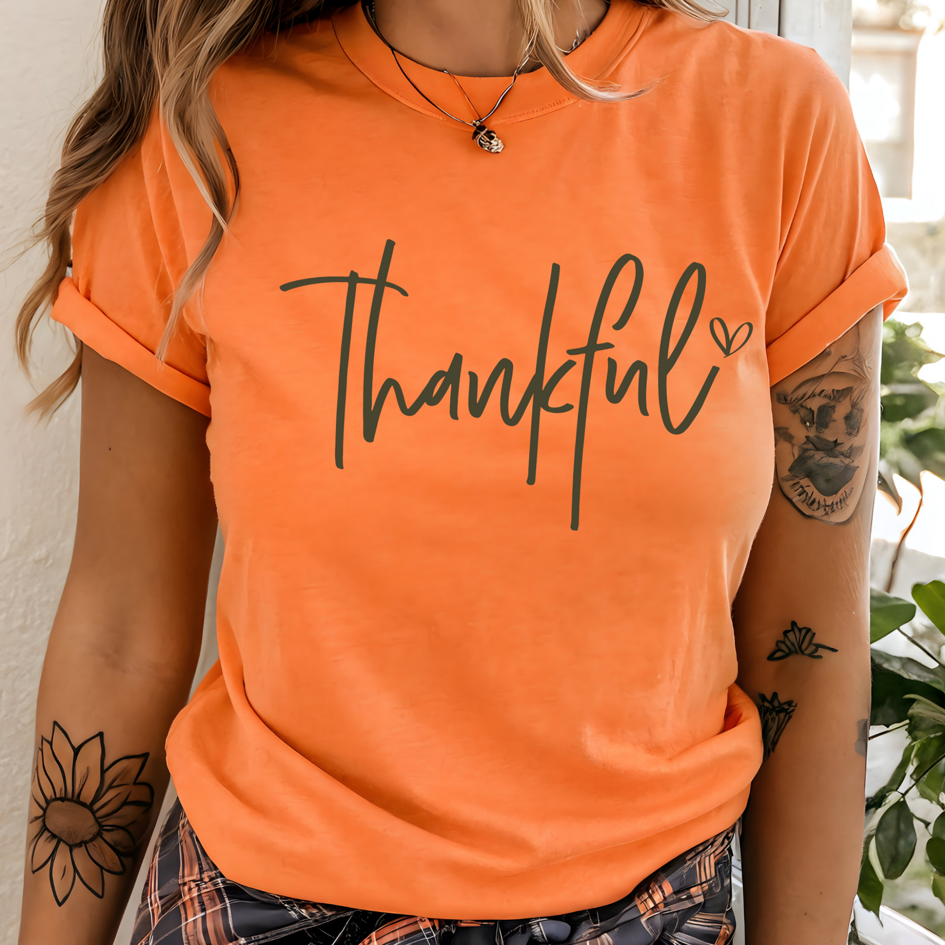 Orange “Thankful” fall T-shirt flat lay on neutral background