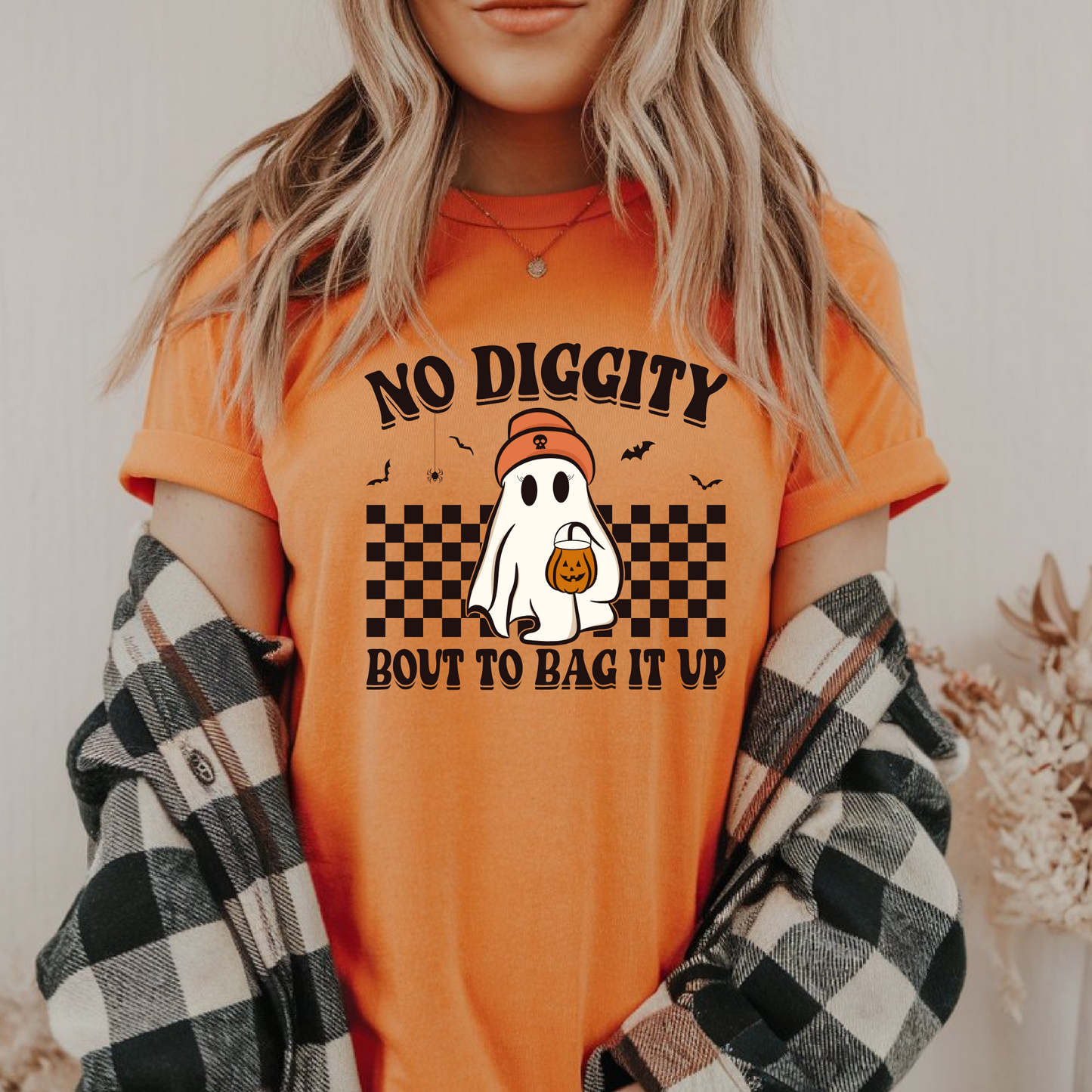Orange fall-themed T-shirt styled with flannel, showcasing playful ghost graphic. Ideal for cozy Halloween outfits and spooky season.