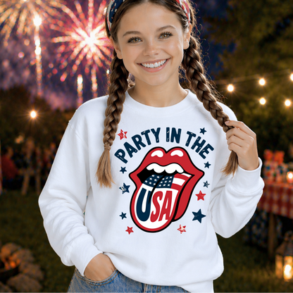 Girl wearing a 'Party in the USA' sweatshirt with fireworks in the background