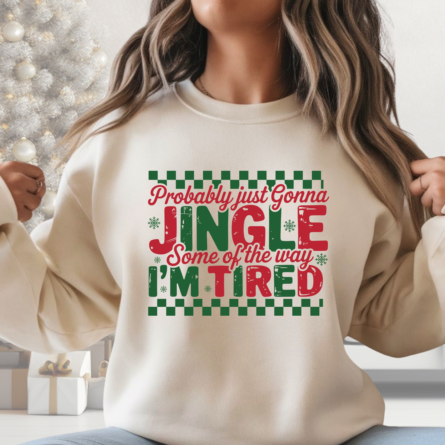 Woman wearing beige “Probably Just Gonna Jingle Some of the Way I’m Tired” Christmas sweatshirt