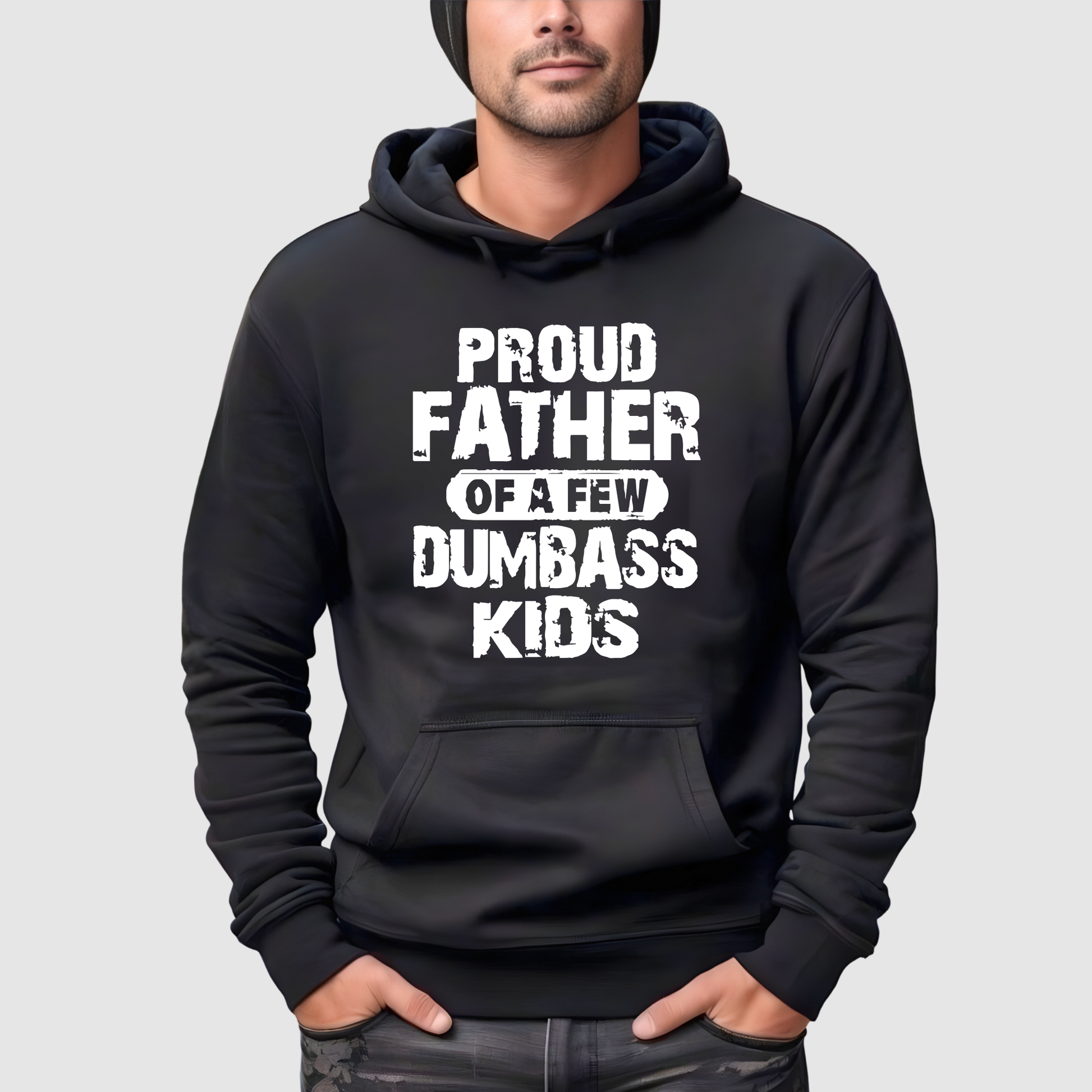 Black hoodie with white text 'PROUD FATHER OF A FEW DUMBBASS KIDS' worn by a person on a light gray background