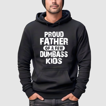 Black hoodie with white text 'PROUD FATHER OF A FEW DUMBBASS KIDS' worn by a person on a light gray background