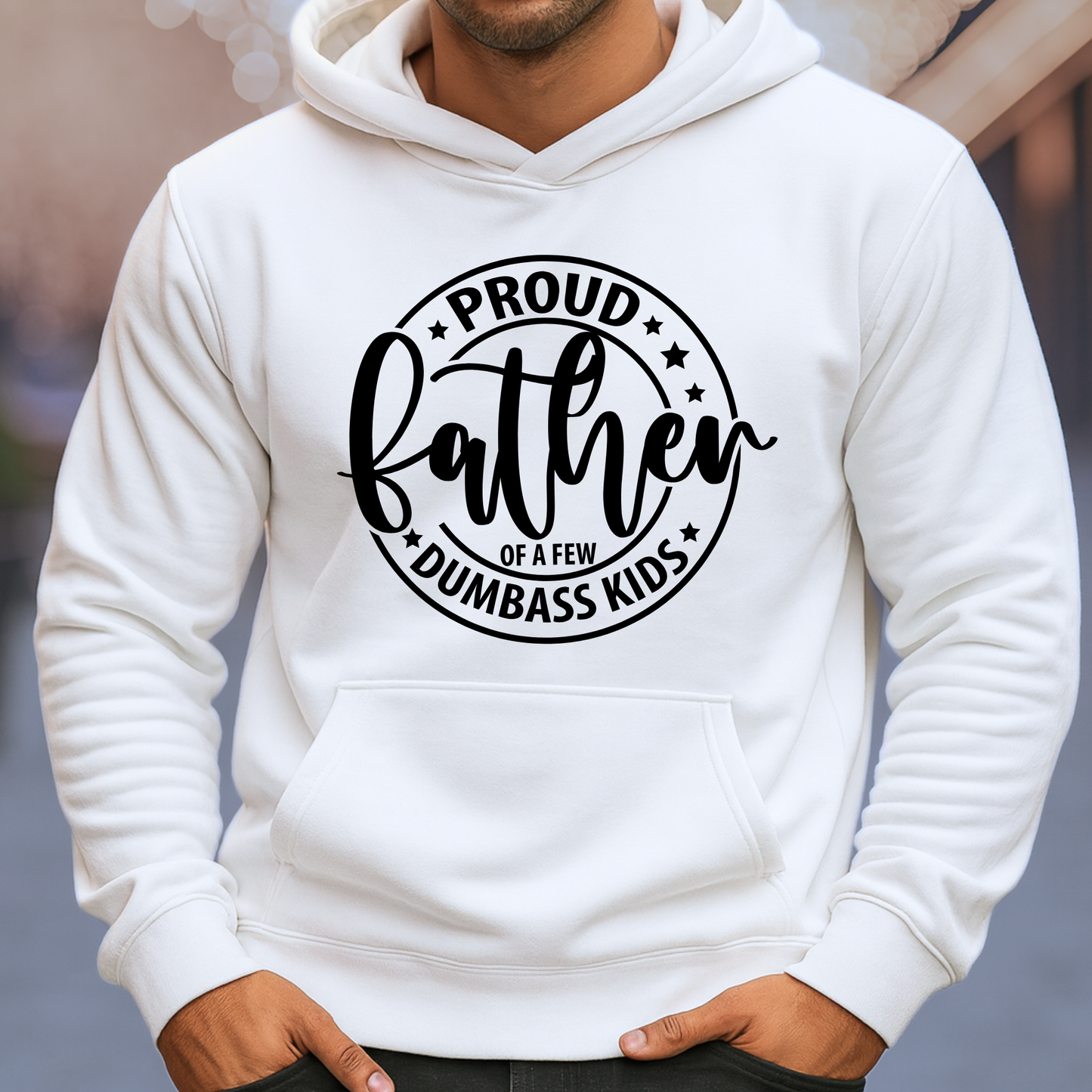White hoodie with 'Proud father of a few dumbass kids' text on a blurred background
