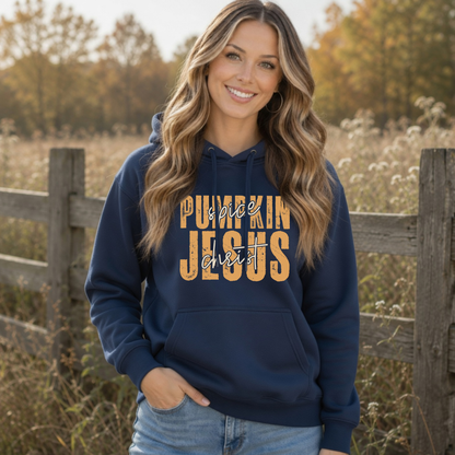 Woman wearing a navy Pumpkin Spice and Jesus Christ hoodie in a warm autumn field setting
