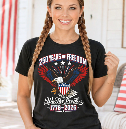 Woman wearing a black t-shirt with a patriotic design featuring an eagle and text about 250 years of freedom.