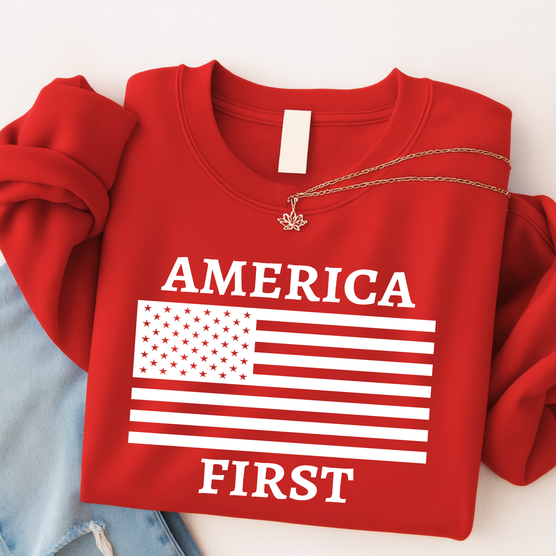 Red America First patriotic women’s unisex sweatshirt with white American flag graphic