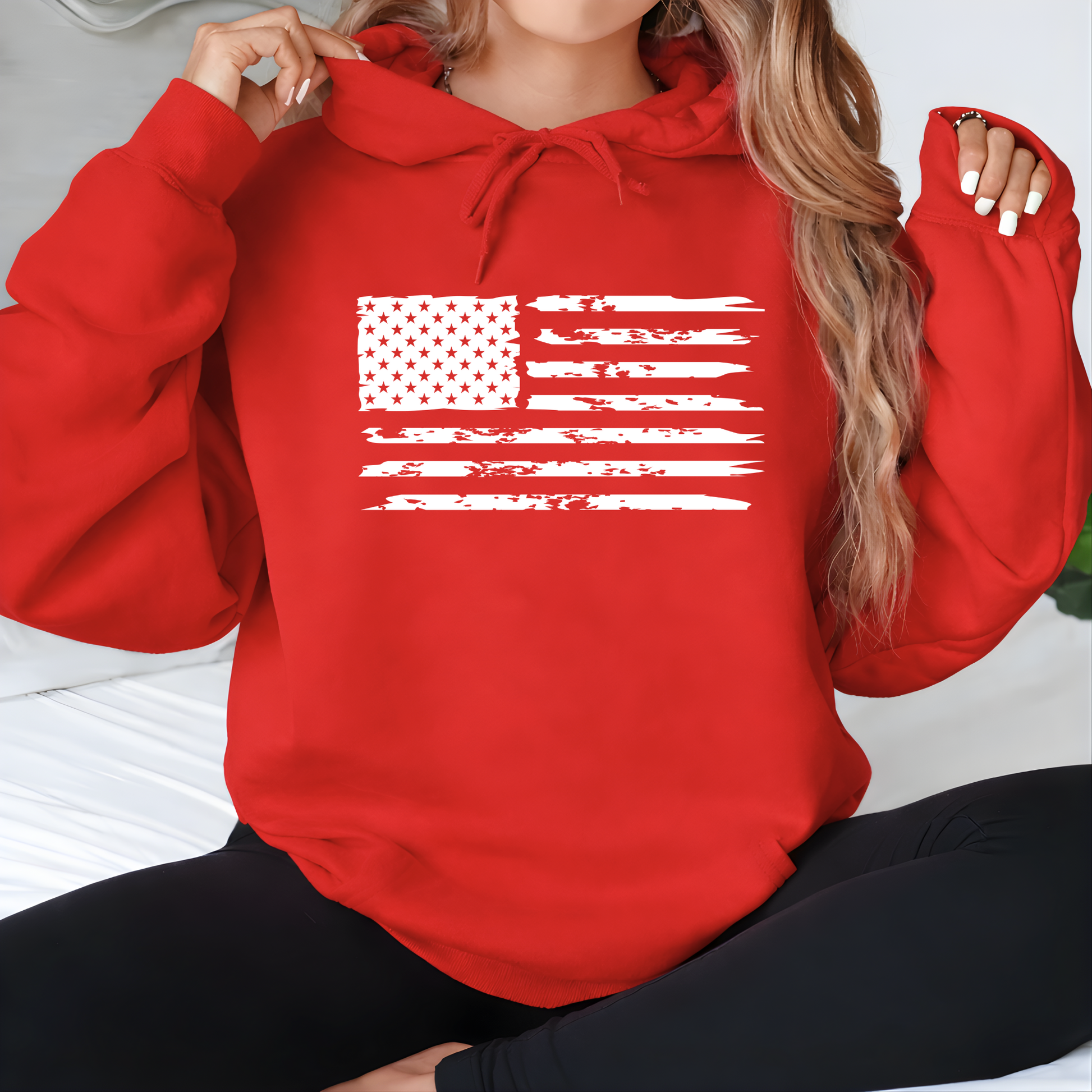 Person wearing a red hoodie with an American flag design.