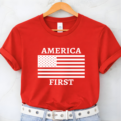 Red t-shirt with 'AMERICA FIRST' text and American flag design on a hanger.