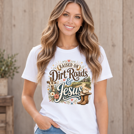 Woman wearing a white Raised on Dirt Roads & Jesus crewneck T-Shirt by a rustic fence.