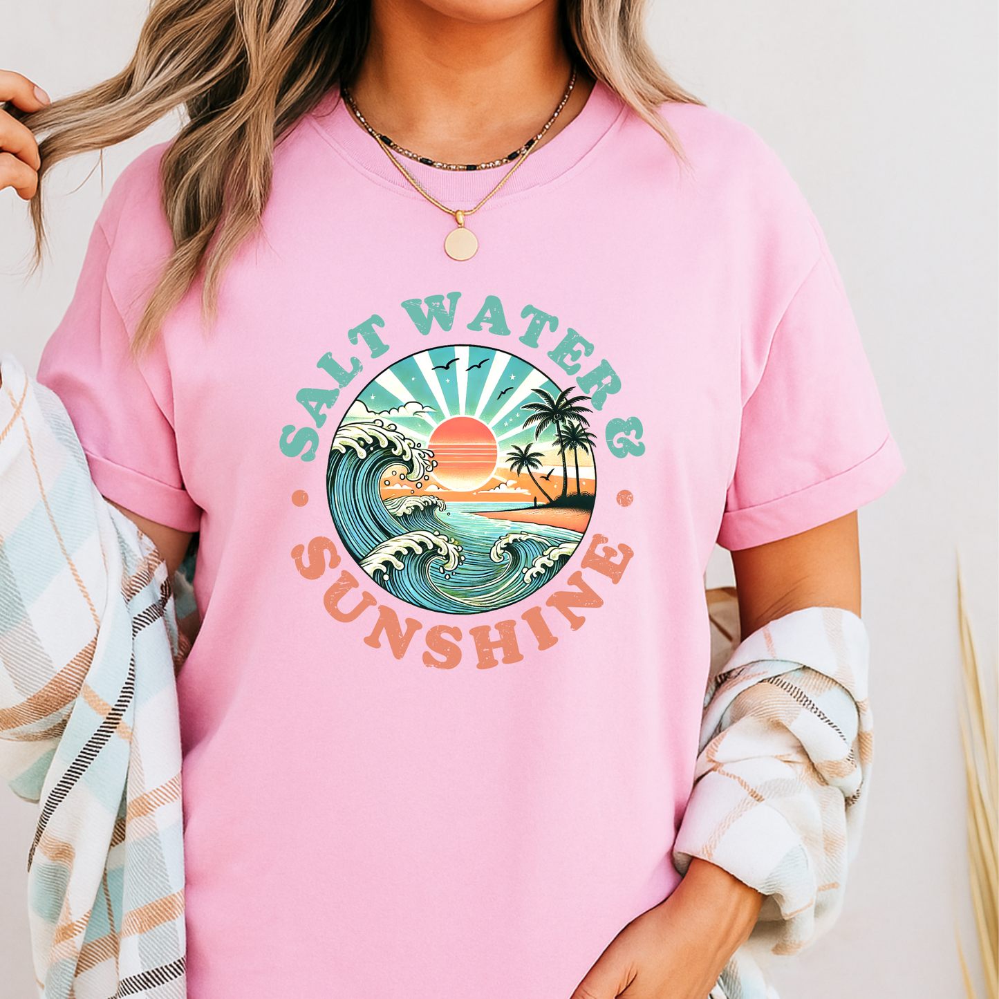 Light pink Salt Water & Sunshine shirt layered with flannel, retro beach look

