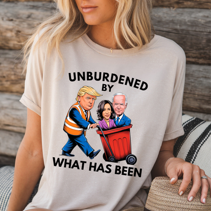 Sand color T-shirt with Unburdened By What Has Been Trump graphic design