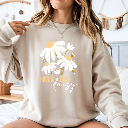 Person wearing a beige sweatshirt with floral design and text