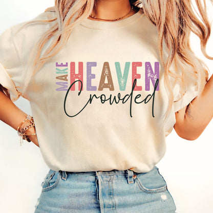 Woman wearing sand-colored Make Heaven Crowded T-shirt with rolled sleeves and denim shorts