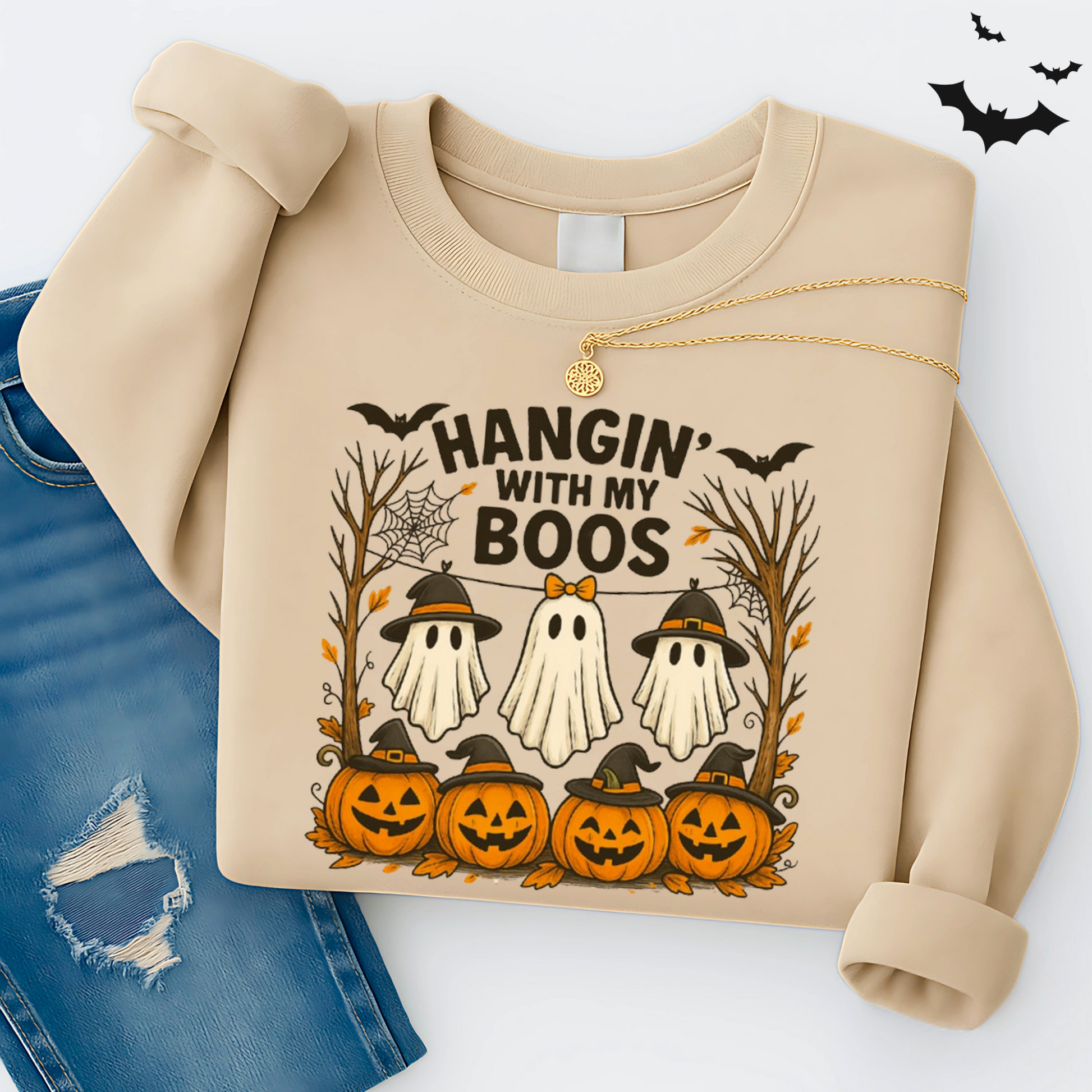 Sand-colored Hangin’ With My Boos sweatshirt with three ghosts wearing witch hats, pumpkins, bats, and fall trees. Cozy unisex Halloween crewneck styled with denim, perfect for spooky season.