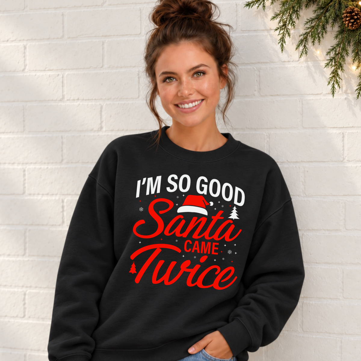 Woman wearing a black sweatshirt with the funny I'm So Good Santa Came Twice holiday design.