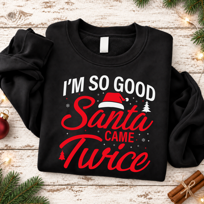 Flat lay of a black sweatshirt featuring the I'm So Good Santa Came Twice holiday graphic.