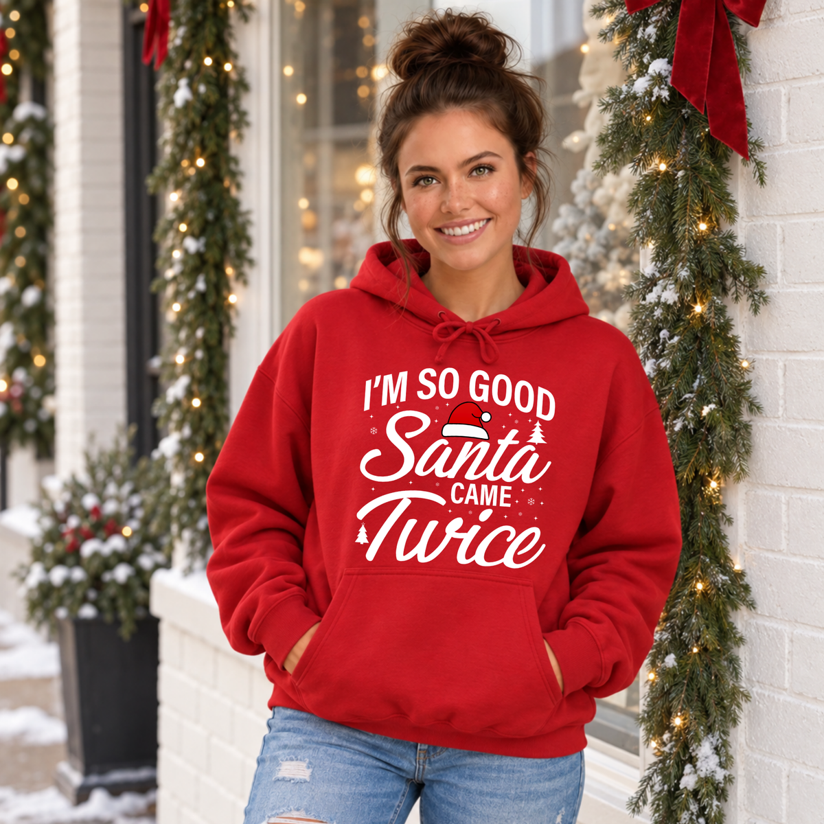 Woman modeling a red hoodie with the I'm So Good Santa Came Twice Christmas graphic.