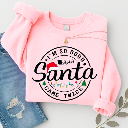 Folded pink Santa Came Twice sweatshirt flat lay with jeans
