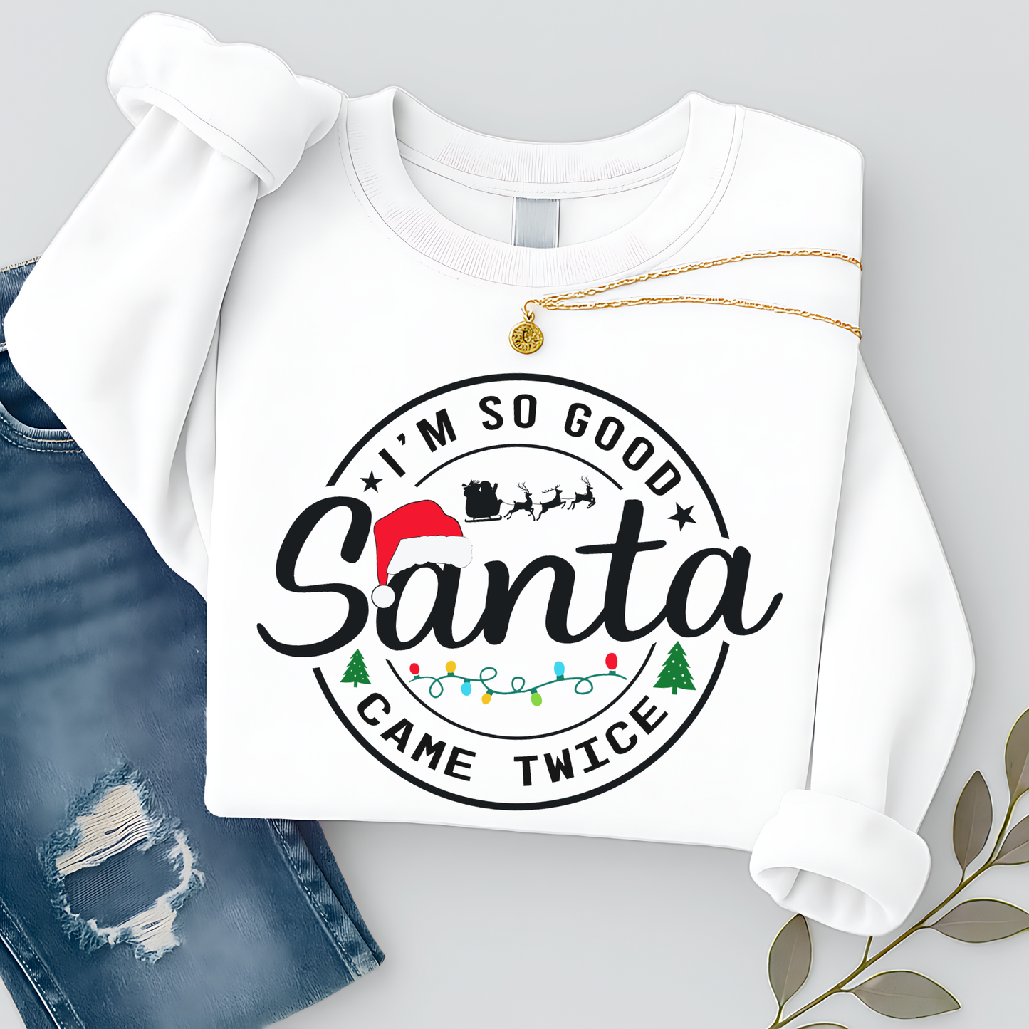 : Folded white Santa Came Twice Christmas crewneck sweatshirt flat lay