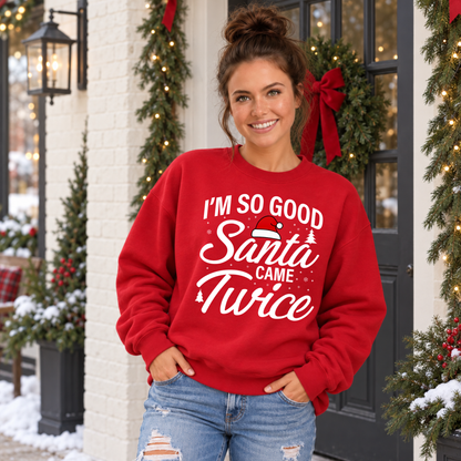 Woman wearing a red crewneck sweatshirt with the I'm So Good Santa Came Twice design.